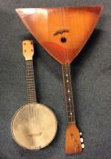 A cased banjo together with a balalaika. Est. £30