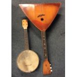 A cased banjo together with a balalaika. Est. £30