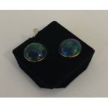 A pair of opal style ear studs in gold mounts. App