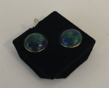 A pair of opal style ear studs in gold mounts. App