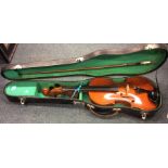 A cased violin together with a bow. Est. £30 - £50