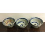 An unusual set of three circular bowls with swirl