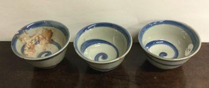 An unusual set of three circular bowls with swirl