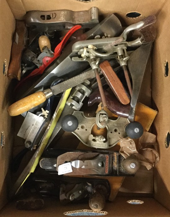 A box of woodworking planes and files.