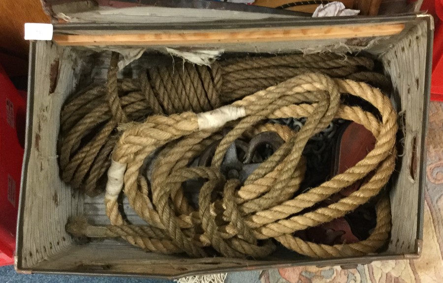 A box containing old ropes and pulleys.