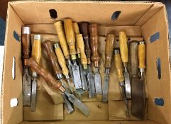 A box containing wooden handled chisels.
