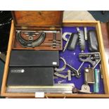 A tray containing measures and clamps.