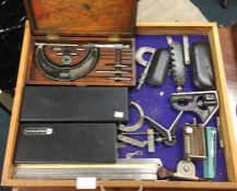 A tray containing measures and clamps.