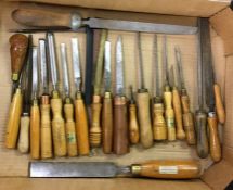 A box containing wooden handled chisels.