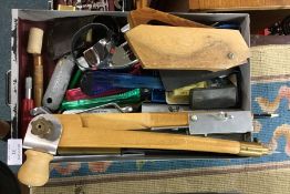 A tray containing staplers and measures.