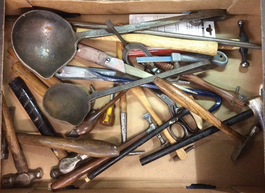 A box containing hammers and other tools.