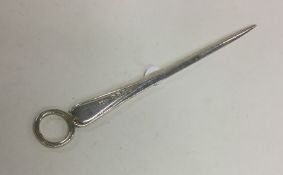 A tapering silver miniature meat skewer with ring