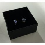 A pair of tanzanite mounted ear studs contained wi