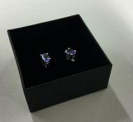 A pair of tanzanite mounted ear studs contained wi