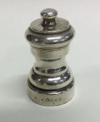 A small Edwardian silver pepper grinder of shaped