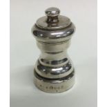 A small Edwardian silver pepper grinder of shaped