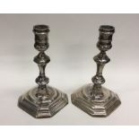 A good pair of cast silver Georgian style candlest