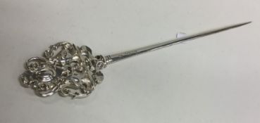 An unusual decorative silver meat skewer with scro