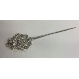 An unusual decorative silver meat skewer with scro