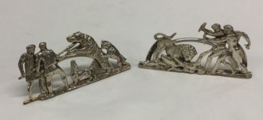 A pair of large silver menu holders depicting hunt