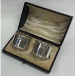 A boxed pair of good quality heavy silver napkin r
