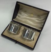 A boxed pair of good quality heavy silver napkin r