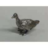 A novelty silver figure of a duck with textured bo