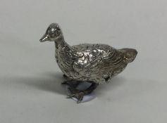 A novelty silver figure of a duck with textured bo