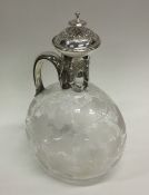 An attractive engraved silver claret jug with lift