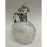 An attractive engraved silver claret jug with lift