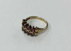 A 9 carat garnet ring with ball decoration. Approx