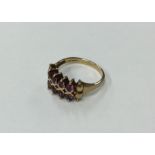 A 9 carat garnet ring with ball decoration. Approx