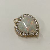A large opal and diamond brooch in the form of a w