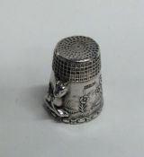 A chased silver thimble decorated with animals. Ap