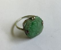 A carved jade ring. 3 grams. Est. £50 - £80.