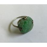 A carved jade ring. 3 grams. Est. £50 - £80.