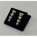A pair of yellow gold and diamond heart shaped ear