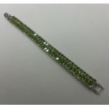 A large peridot two row bracelet set in silver wit