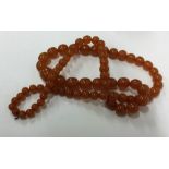 A graduated string of amber beads. Approx. 107 gra