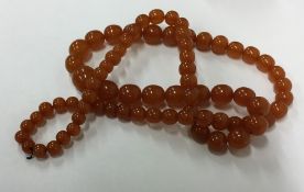 A graduated string of amber beads. Approx. 107 gra