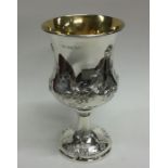 A chased Victorian silver goblet with gilt interio