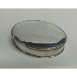 An 18th Century oval silver box with lift-off cove
