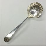 An 18th Century Georgian shell shaped sauce ladle.