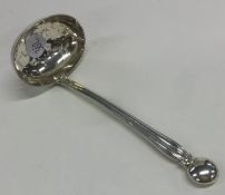 A silver pierced sifter ladle with fluted handle.