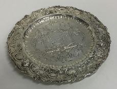 An attractive circular silver dish embossed with f