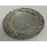 An attractive circular silver dish embossed with f