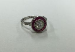 An attractive ruby and diamond circular cluster ri