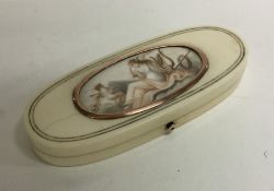 An attractive oval gold and ivory box with waterco