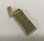 An engine turned gold plated Dunhill lighter. Appr