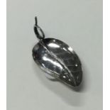 A Victorian silver leaf shaped caddy spoon with en